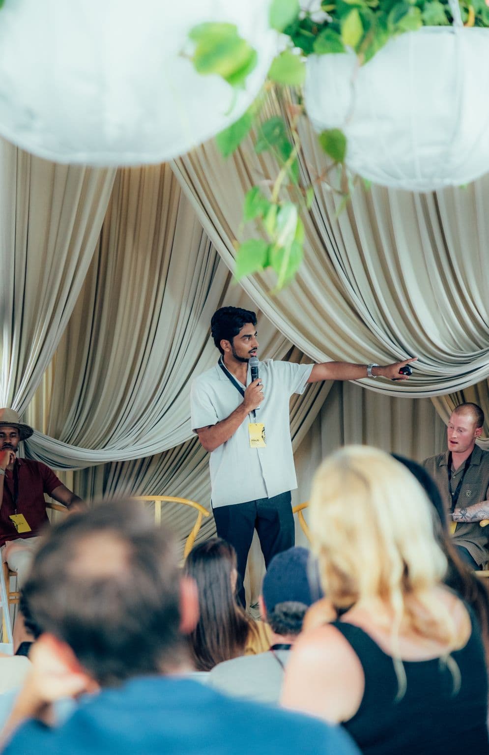 Shaz Mathew speaking on stage